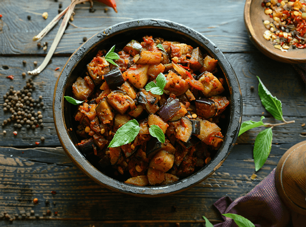 Delicious Brinjal Fry showcasing a golden crispiness, prepared with the richness of cold-pressed groundnut oil.